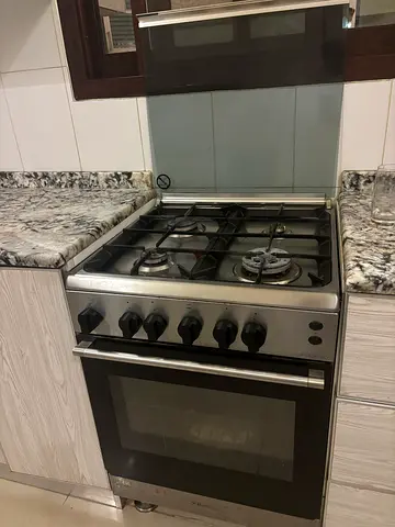 stainless‑steel gas stove with an oven, *Made in Italy*,