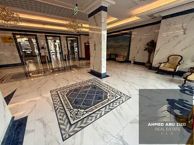 1BR + living room in Al Nuaimiya 3 behind Dubai Islamic Bank – open balcony, 2 baths, equipped kitchen, appliances, free parking, luxury finish.