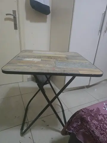 Foldable wooden-top table with metal frame