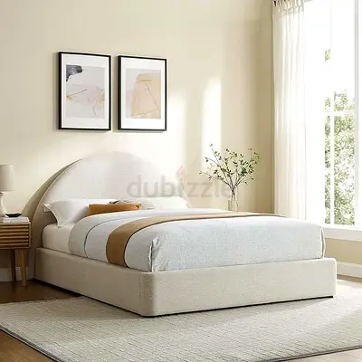 My beige upholstered platform bed with rounded headboard