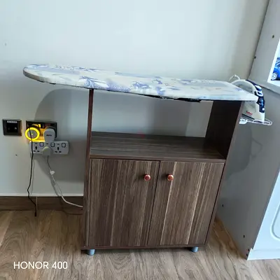 Ironing board with built-in storage cabinet