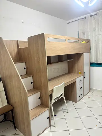 Loft bed with built-in desk, drawers and storage stairs