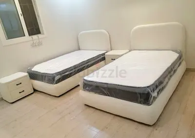 single beds with new mattresses and bedside tables