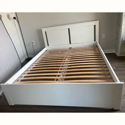 White wooden bed frame with slatted base — good condition