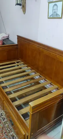 Solid wooden bed frame with headboard and slats along with an underbed