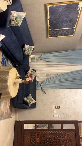 An elegant sofa with cushions and an armchair, one for one and two seaters and roof lamp