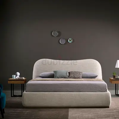 Upholstered bed with curved headboard — good condition