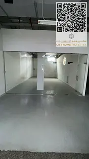 Commercial shop for rent in Al Karama, Ajman, inside a busy mall, with a large space and ready finis