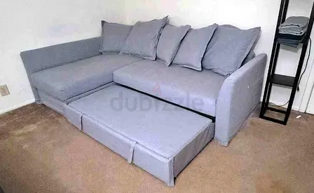 Light grey L-shaped sofa bed with pull-out bed