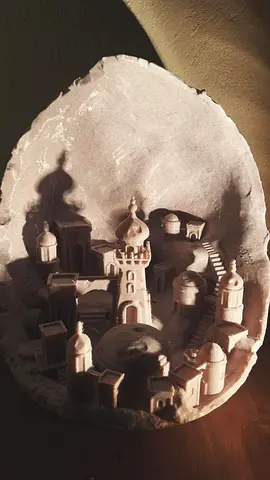 Hand-carved miniature stone city inside egg-shaped geode