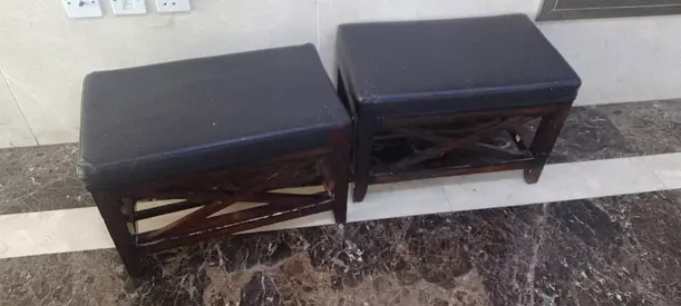 Pair of wooden stools with cushioned tops