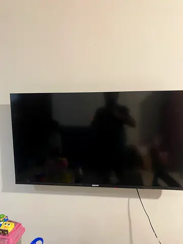 LED LCD flat panel TV — wall-mounted, working condition