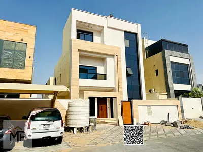 Luxury villa for sale in Al Yasmin, Ajman, in a prime location on a main road. Electricity and water connections are included in the price.