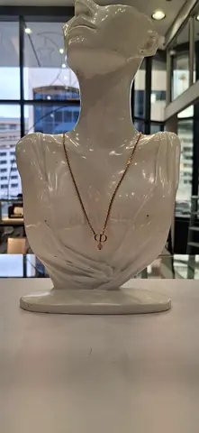 Delicate gold chain necklace with small circular pendant