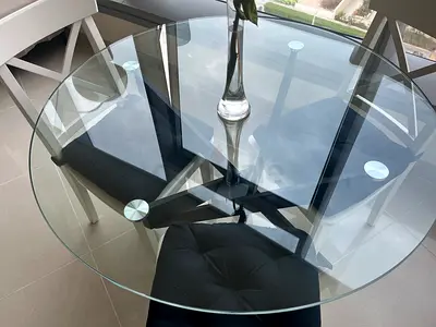 Round glass-top dining table