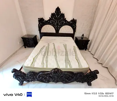 Luxurious crafted wooden bed, side tables  mattress