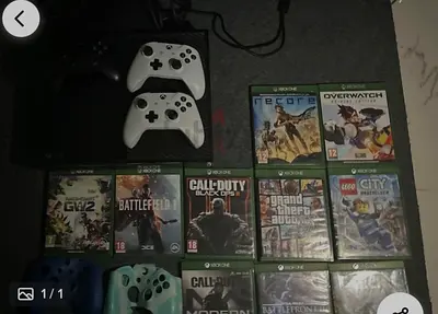 xbox one console + 3 controllers + 10 good as new cds + 2 controller cover.