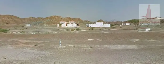 A plot of land for sale in Masfout 11, a very prime location and a large area.