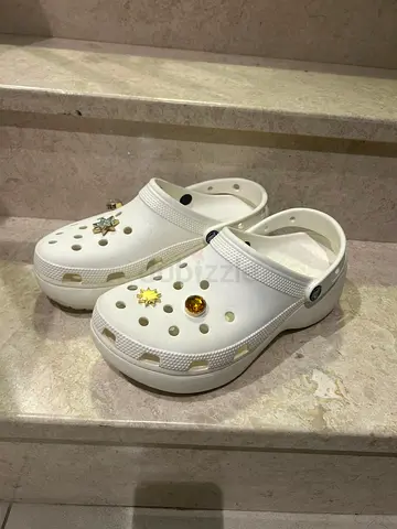 White Crocs-style slip-on clogs with charms (lightly used)