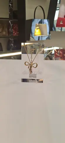 Delicate gold bow pendant necklace with crystal charm - lightly worn