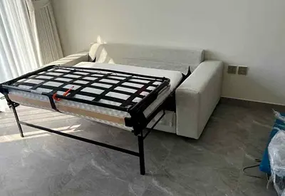 My light grey fabric sofa bed with pull-out metal frame — good condition