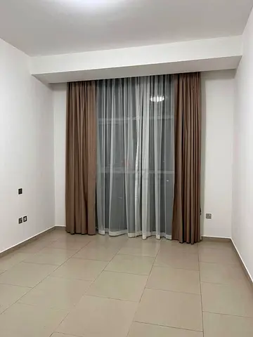 Beige blackout curtains with white sheer panels