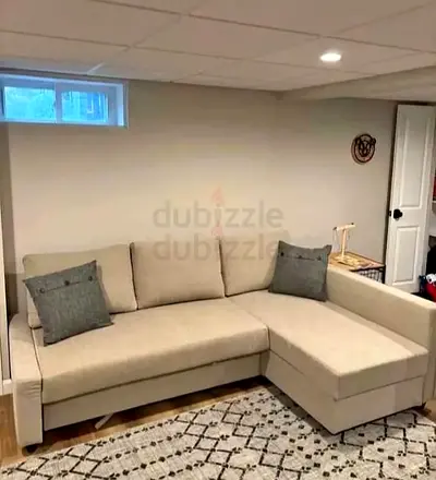 Beige L-shaped sofa with right-side chaise - good condition