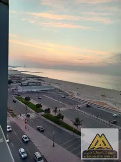 Two-bedroom apartment with a living room on the corniche, sea view, prime location, and 24-hour serv