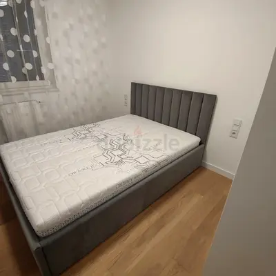 New Grey upholstered single bed frame with mattress and channel headboard
