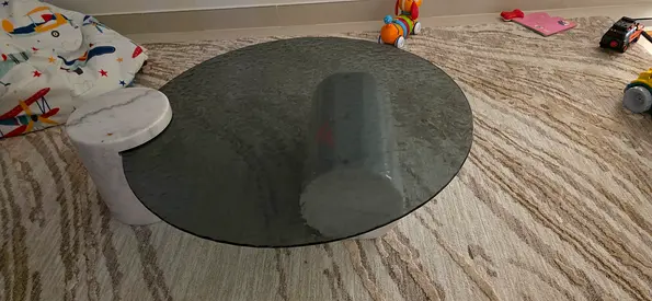 Round smoked glass coffee table with concrete base (good condition)