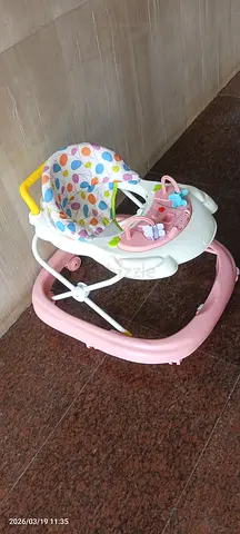 My baby walker with padded seat and toy tray