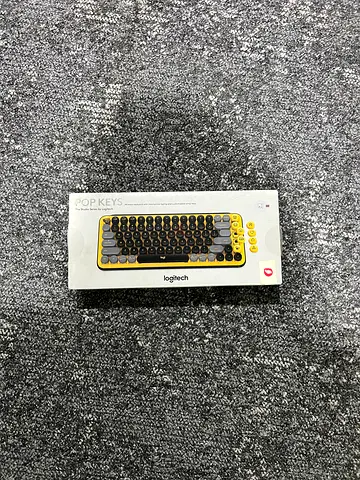 Im selling my Logitech POP Keys wireless mechanical keyboard (yellow) — boxed