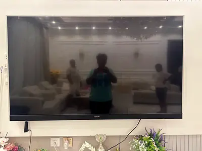 Large wall-mounted flat panel TV — good condition