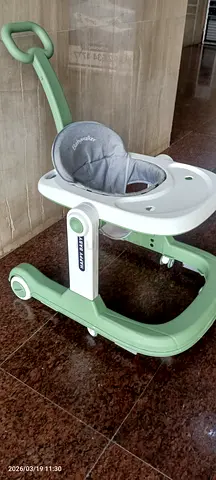 Gently used baby walker with tray and push handle