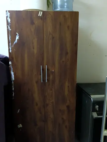 Two-door wooden wardrobe (used) — sturdy storage, some wear