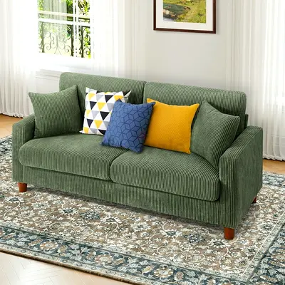 Oversized green corduroy fabric loveseat