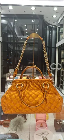 Gold quilted handbag with chain strap