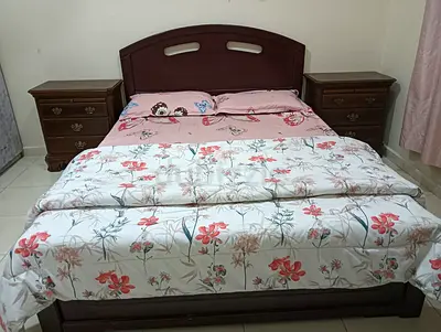 Wooden Bed with Nightstands and Floral Bedding