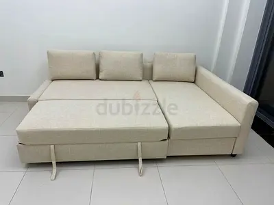 Beige L-shaped convertible sofa bed - good condition
