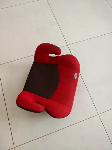 Red backless booster car seat — used, clean