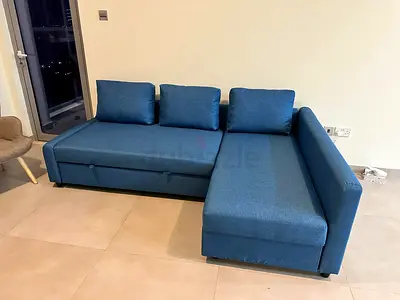 Blue L-shaped sofa bed with chaise - good condition