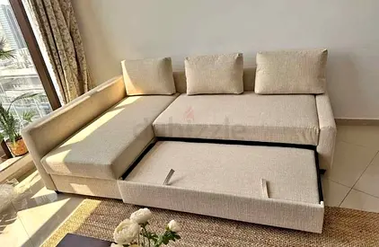My beige L-shaped sofa bed with storage - good condition