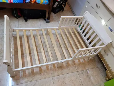 White wooden baby crib - used slatted frame