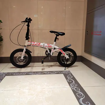 Compact white folding bike - 1 year used, rides well.