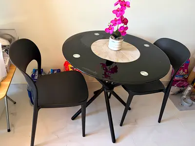Round glass dining table with 2 black chairs - compact set