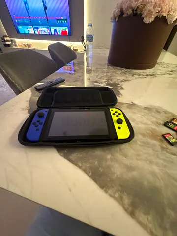 Nintendo Switch with neon Joy-Cons, carry case and game cartridges (WE CAN NEGOTIATE)