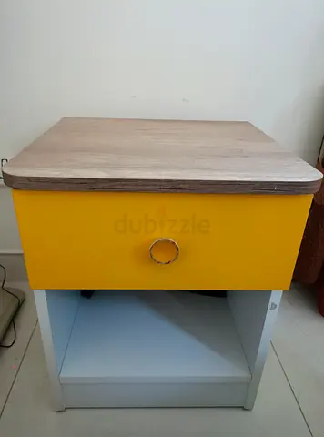 Compact wood-top nightstand with yellow drawer and open shelf