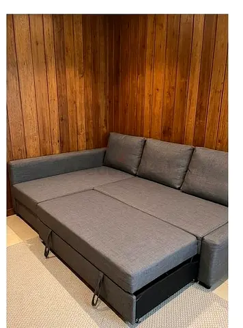 Gray L-shaped sofa bed with pull-out and storage, good condition