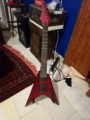 My V-shaped electric guitar (used, solid-body) red