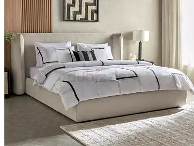 Elegant Beige Upholstered Bed with Bedding